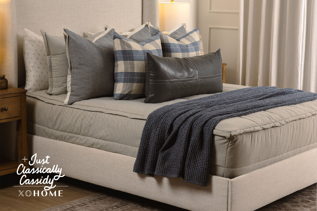 Soft, blue and white striped zipper bedding with grey, plaid, and blue accessories.