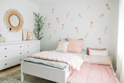
      A little girls room with floral wall decals and a trundle bed made with zipper bedding.
    
