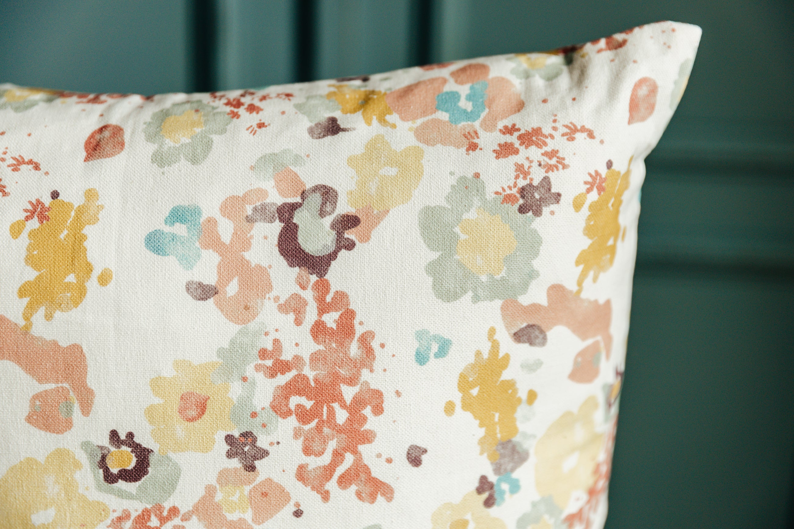 A close up on the colorful details of this floral throw pillow.