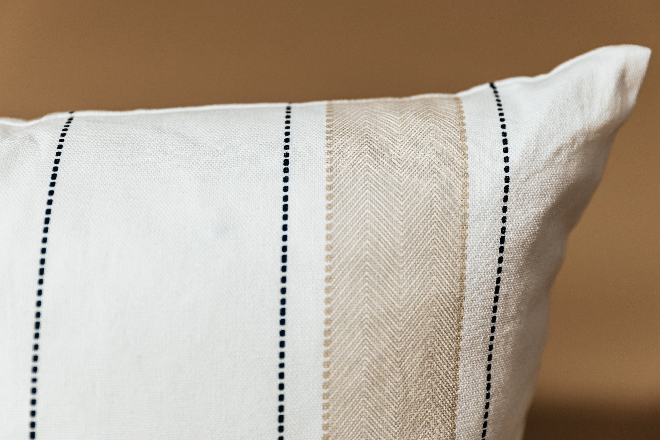 A close up on the Ryan stripe pillow to showcase the detailed stitching on the exterior.