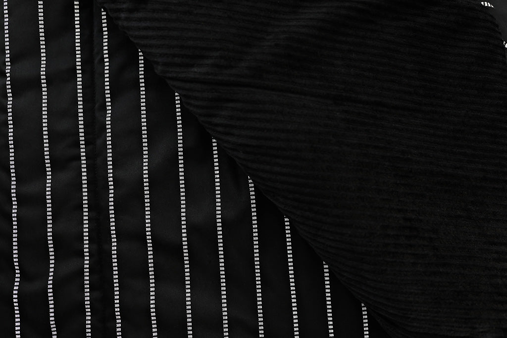black blanket with dotted white stripes and soft black minky interior