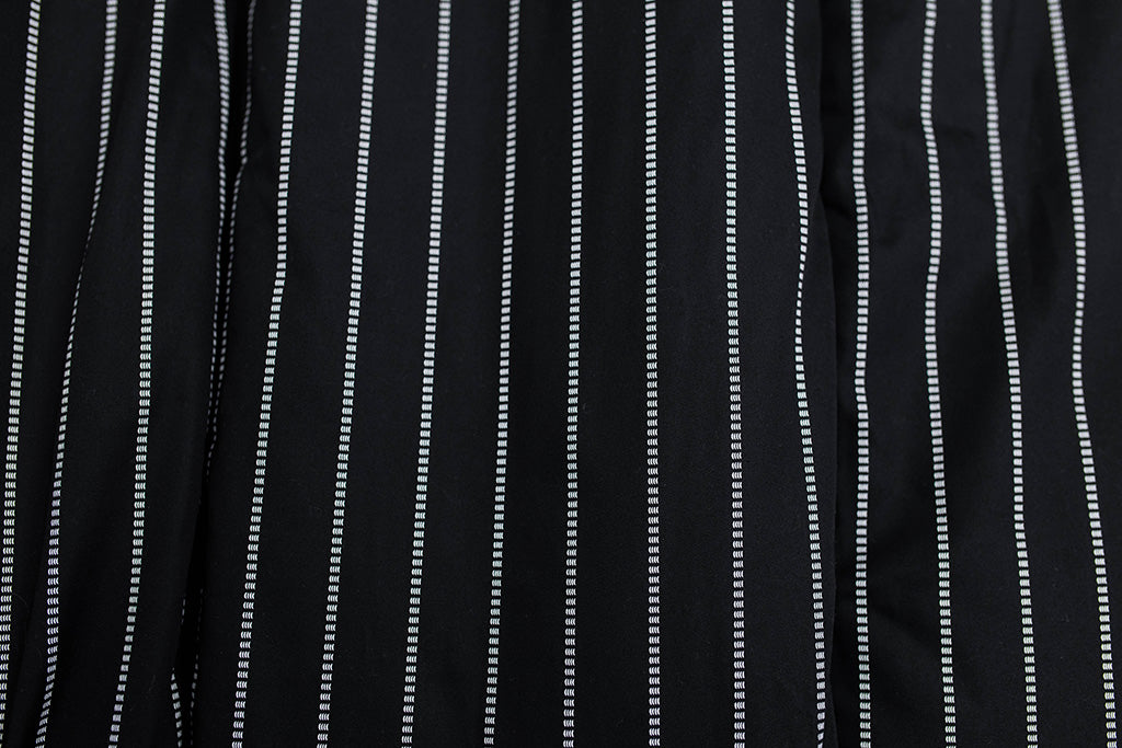 A close up view of the exterior of a black and white striped blanket