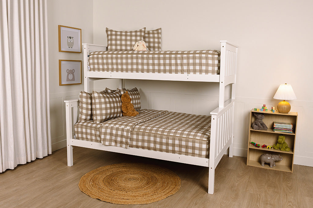 A bunk bed with the top twin and bottom full made with tan gingham printed zipper bedding.