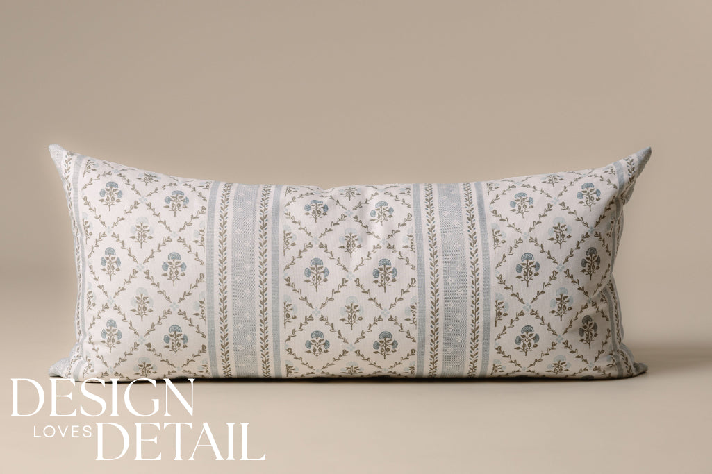A blue and white floral XL lumbar pillow on a cream background.