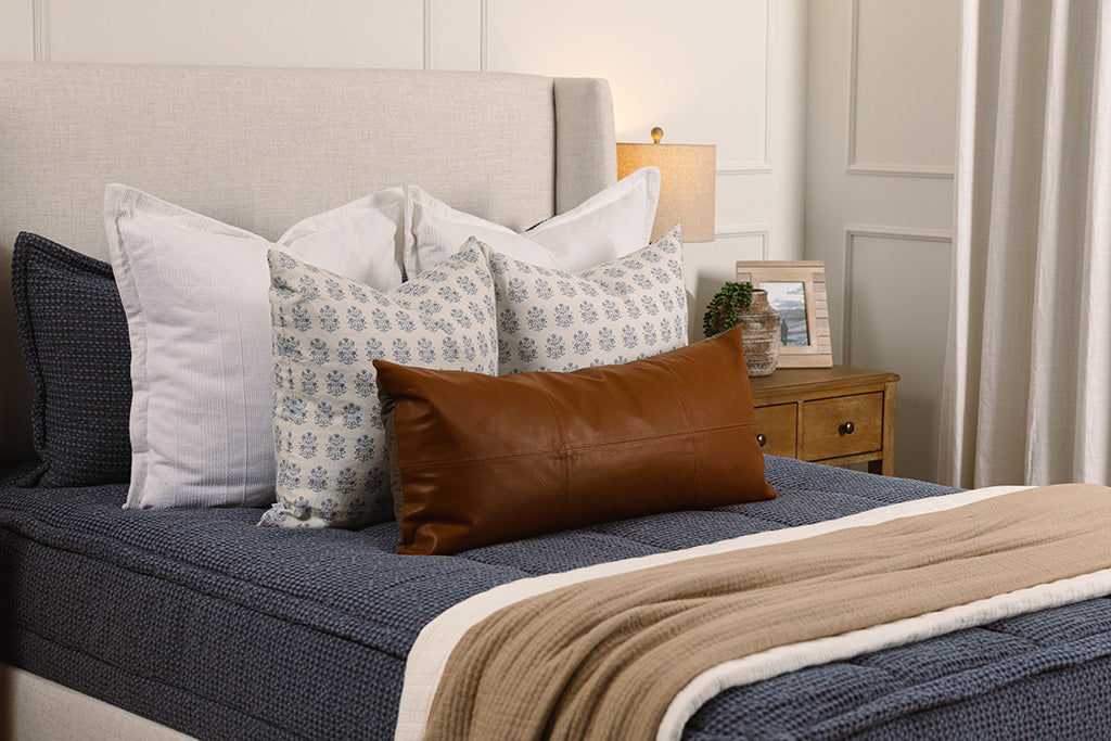 Soft, blue waffle texture zipper bedding with tan ,white, and floral accessories.