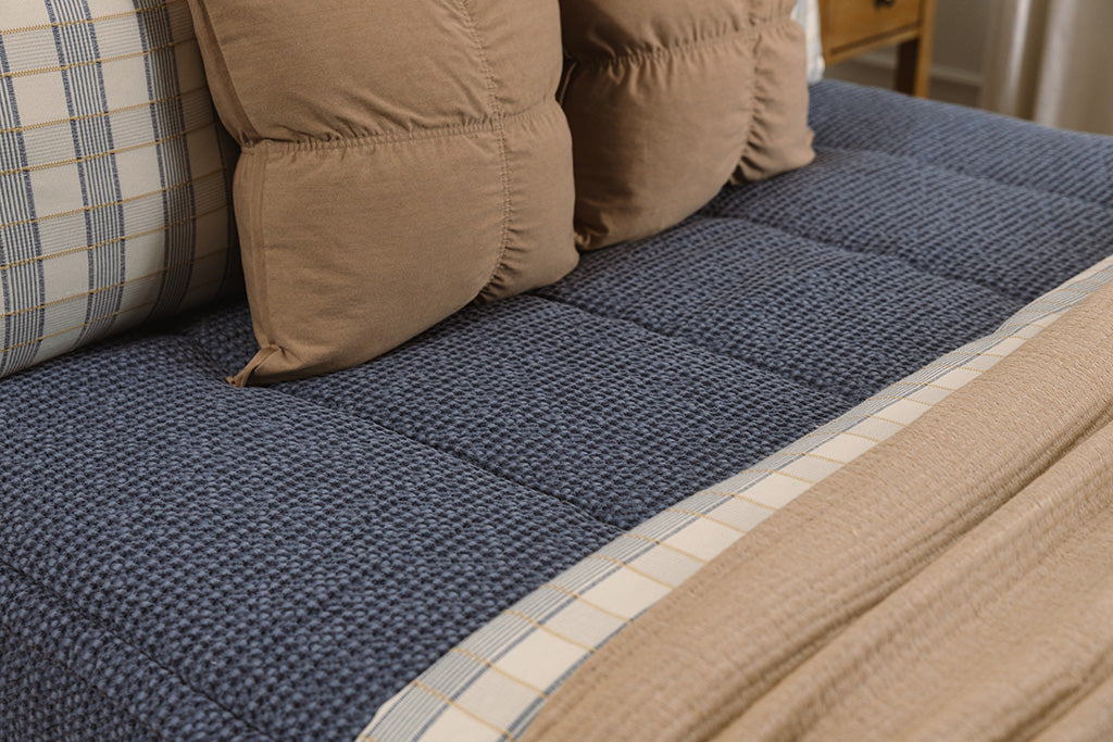 Close up photo of blue waffle texture zipper bedding.
