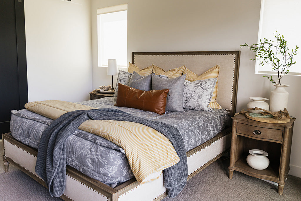 A cream sketched floral pattern with a charcoal base zipper bedding with gray, yellow and rustic accessories.