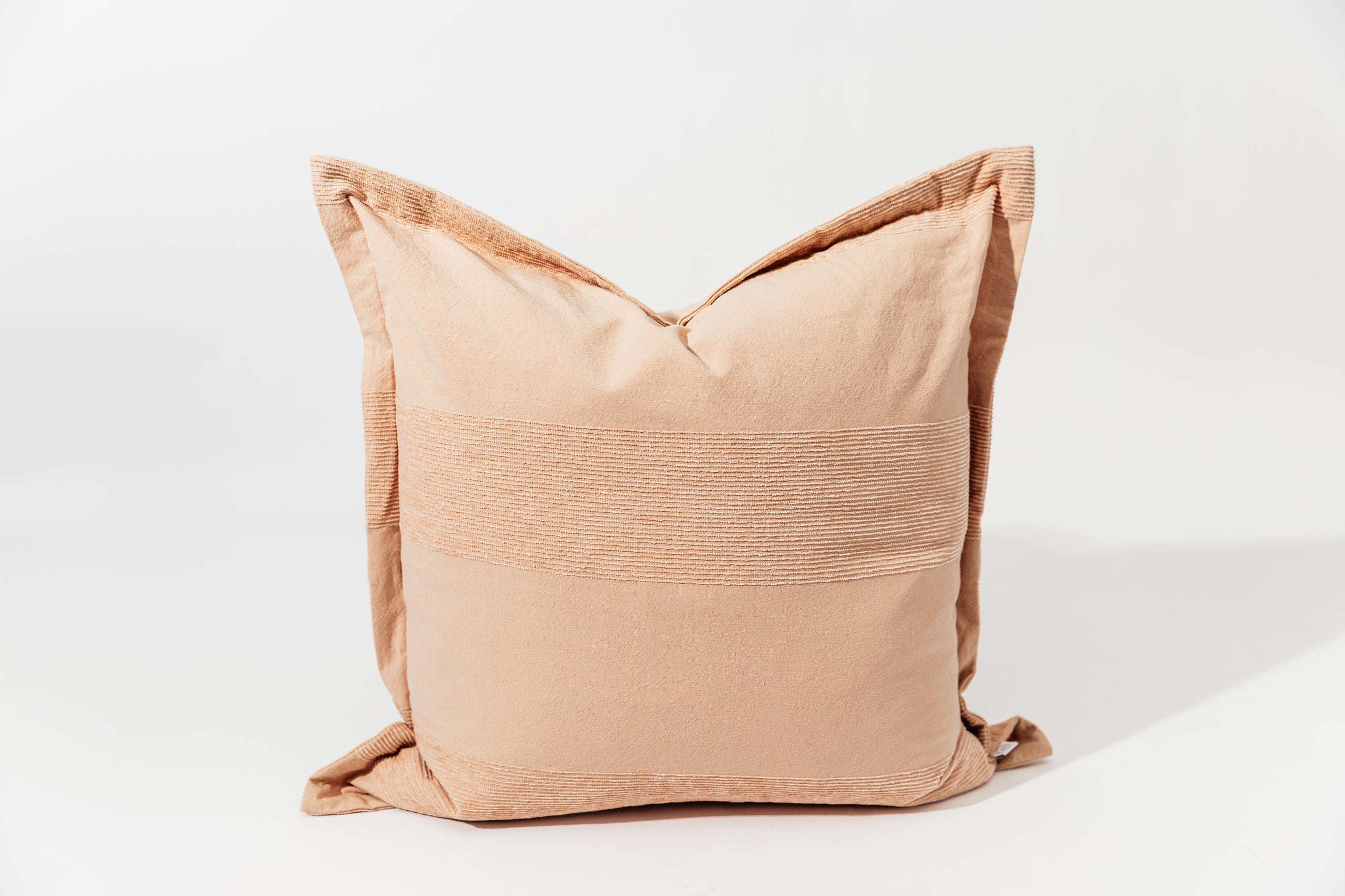 A pink euro pillow with a faded striped arranged on a white background.
