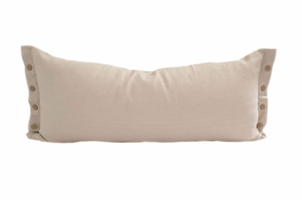 A cream XL lumbar pillow with a row of four buttons on each end