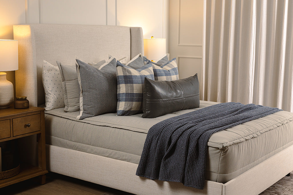 Soft blue knitted zipper bedding with blue, plaid, and grey accessories. 