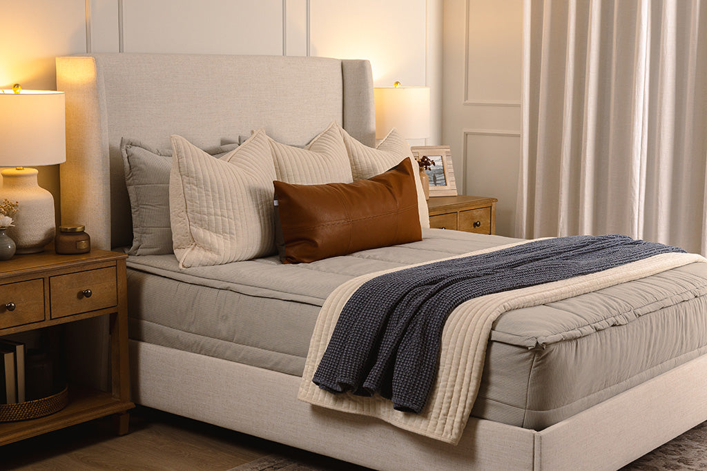 Blue and white stripe zipper bedding with cream, blue, and brown accessories.