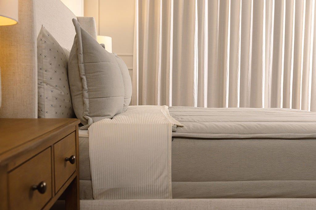 Side view of blue and white striped  zipper bedding.