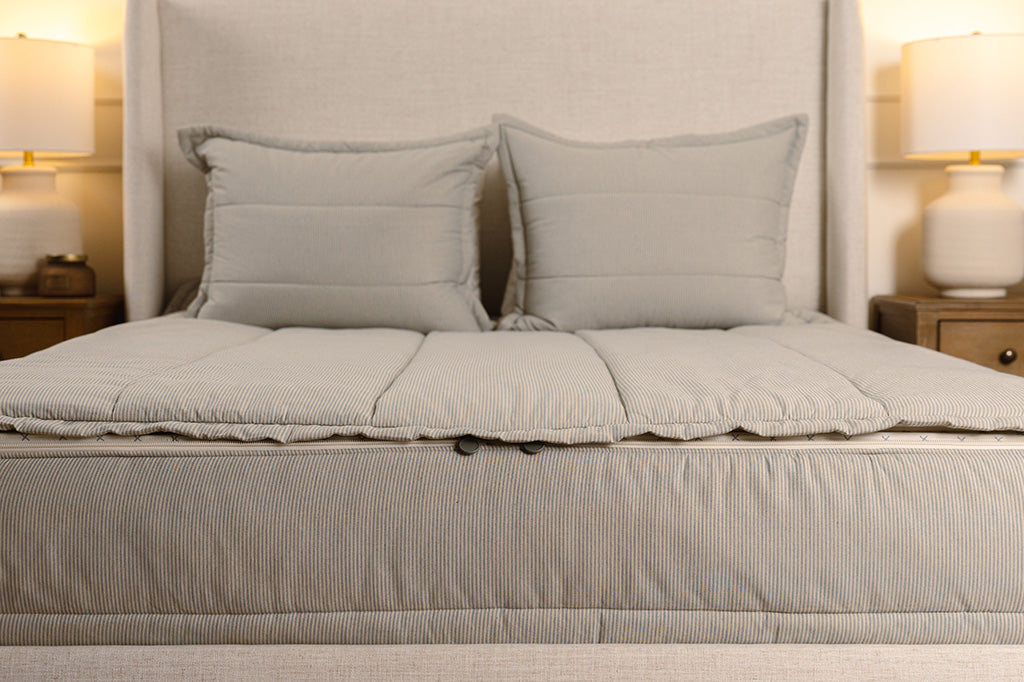 End of a bed showing double zippers on blue and white striped zipper bedding.