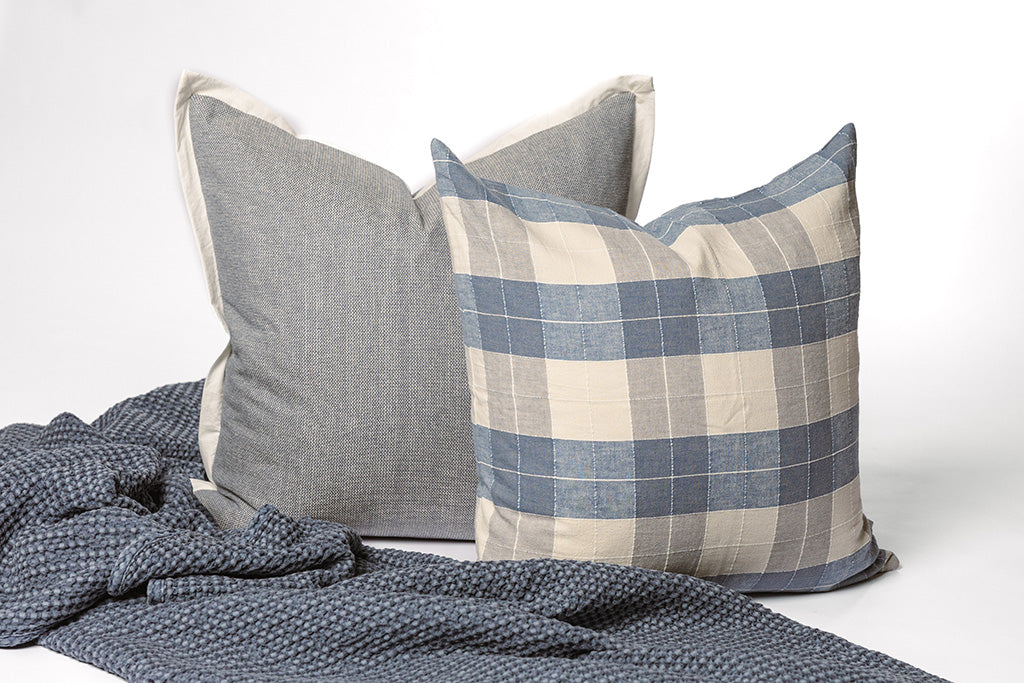 Blue and plaid accessories on a white backdrop.