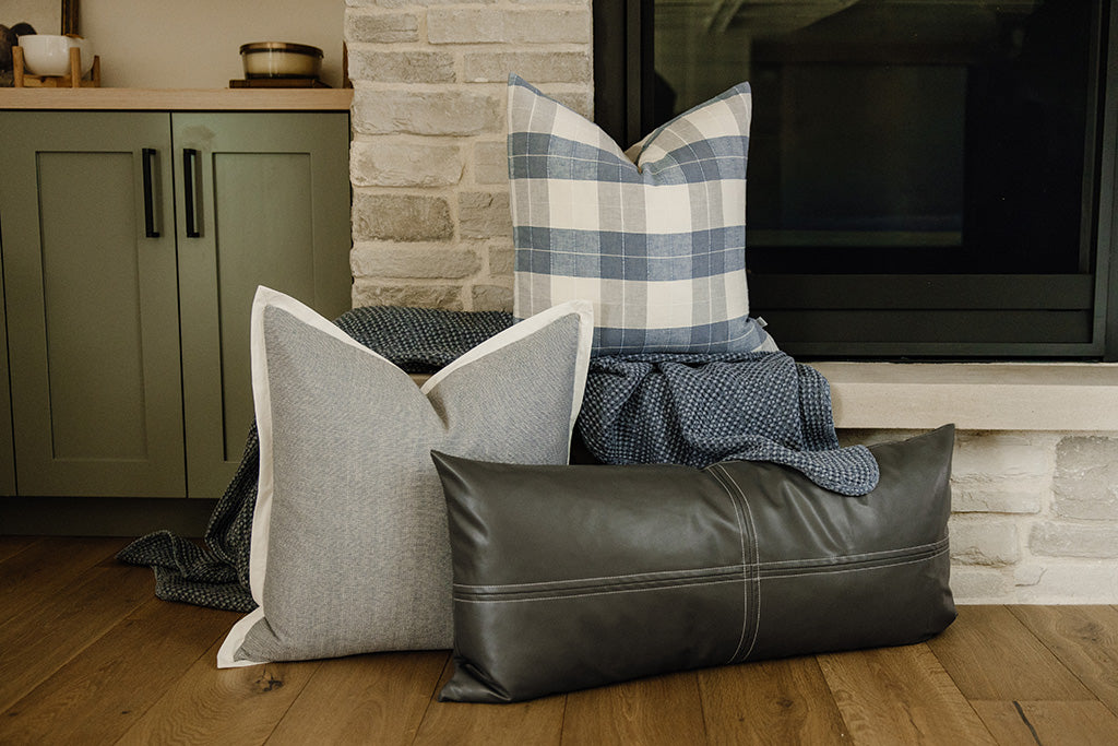 Blue, plaid, and grey accessories placed on a hearth.