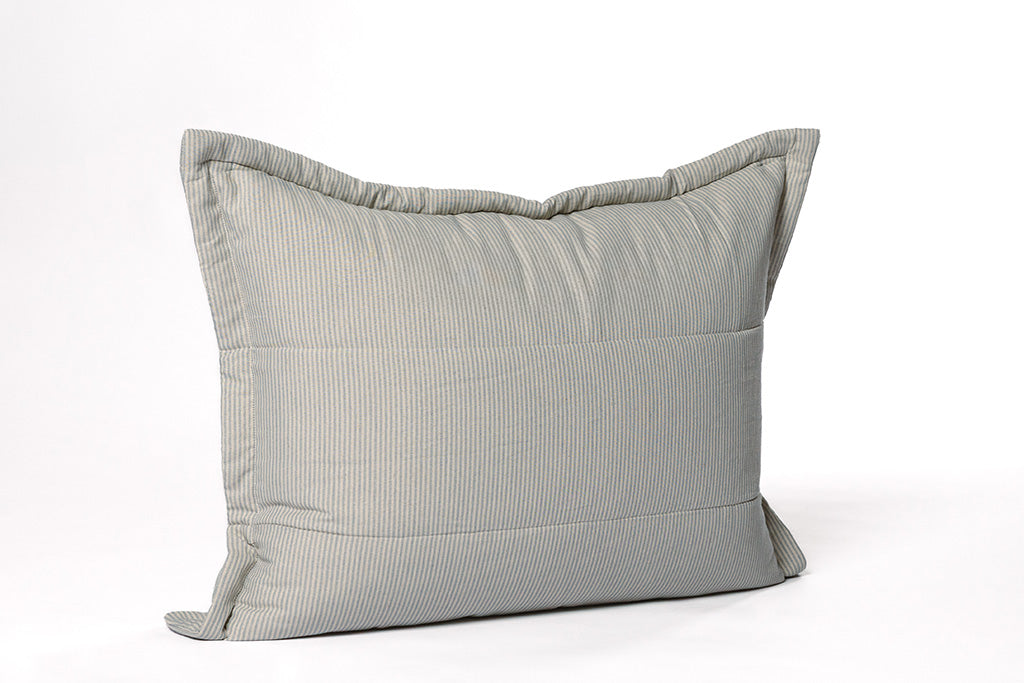 A soft white and light blue striped sham on a white backdrop.
