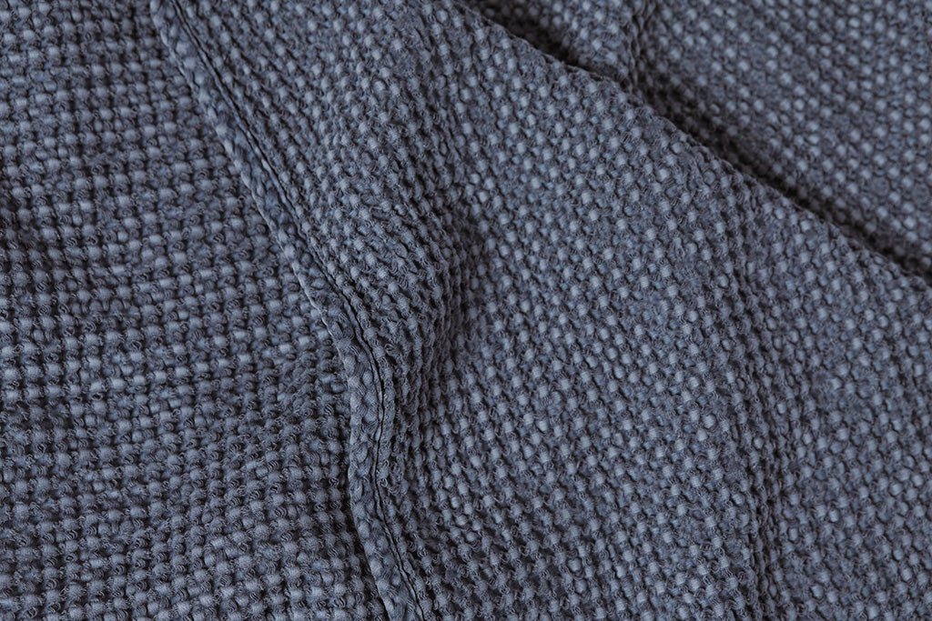 Dusty blue grid throw blanket.