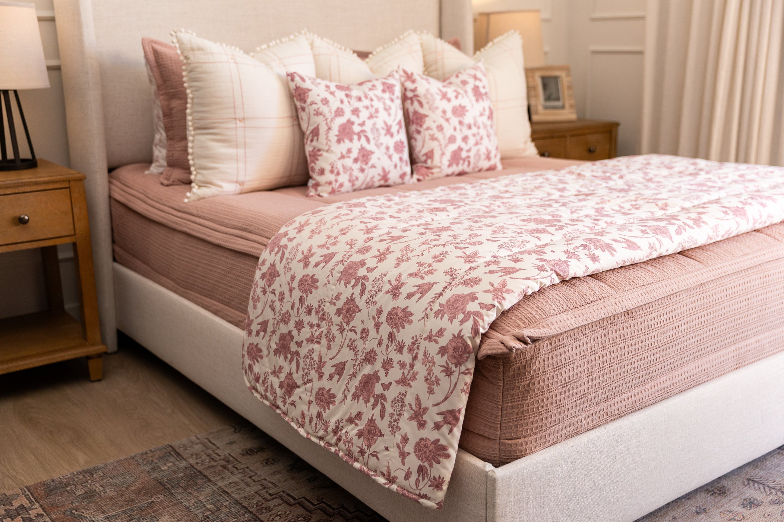 Pink and white floral blanket on pink zipper bedding.