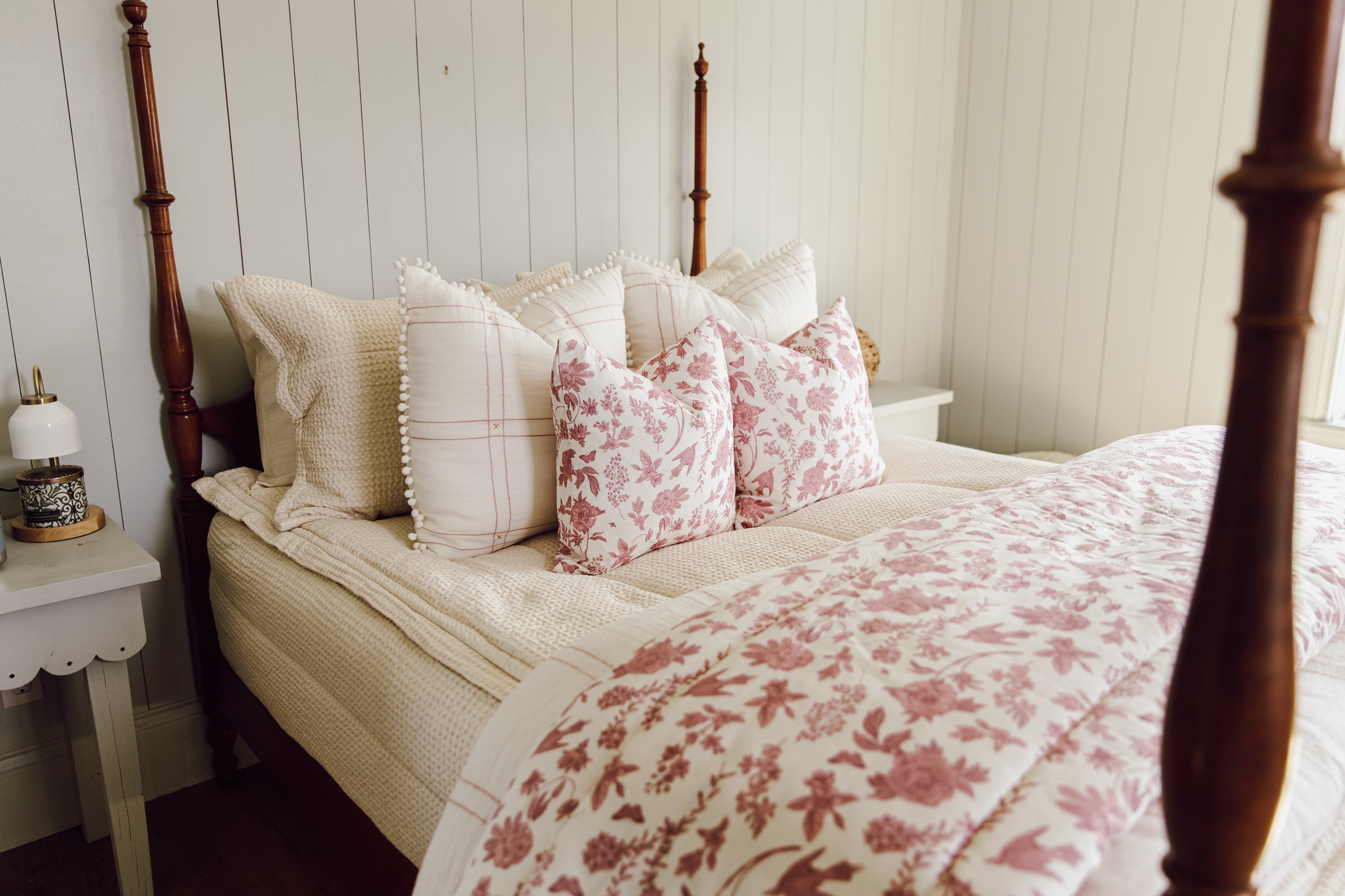 White and Pink floral blanket on cream zipper bedding.