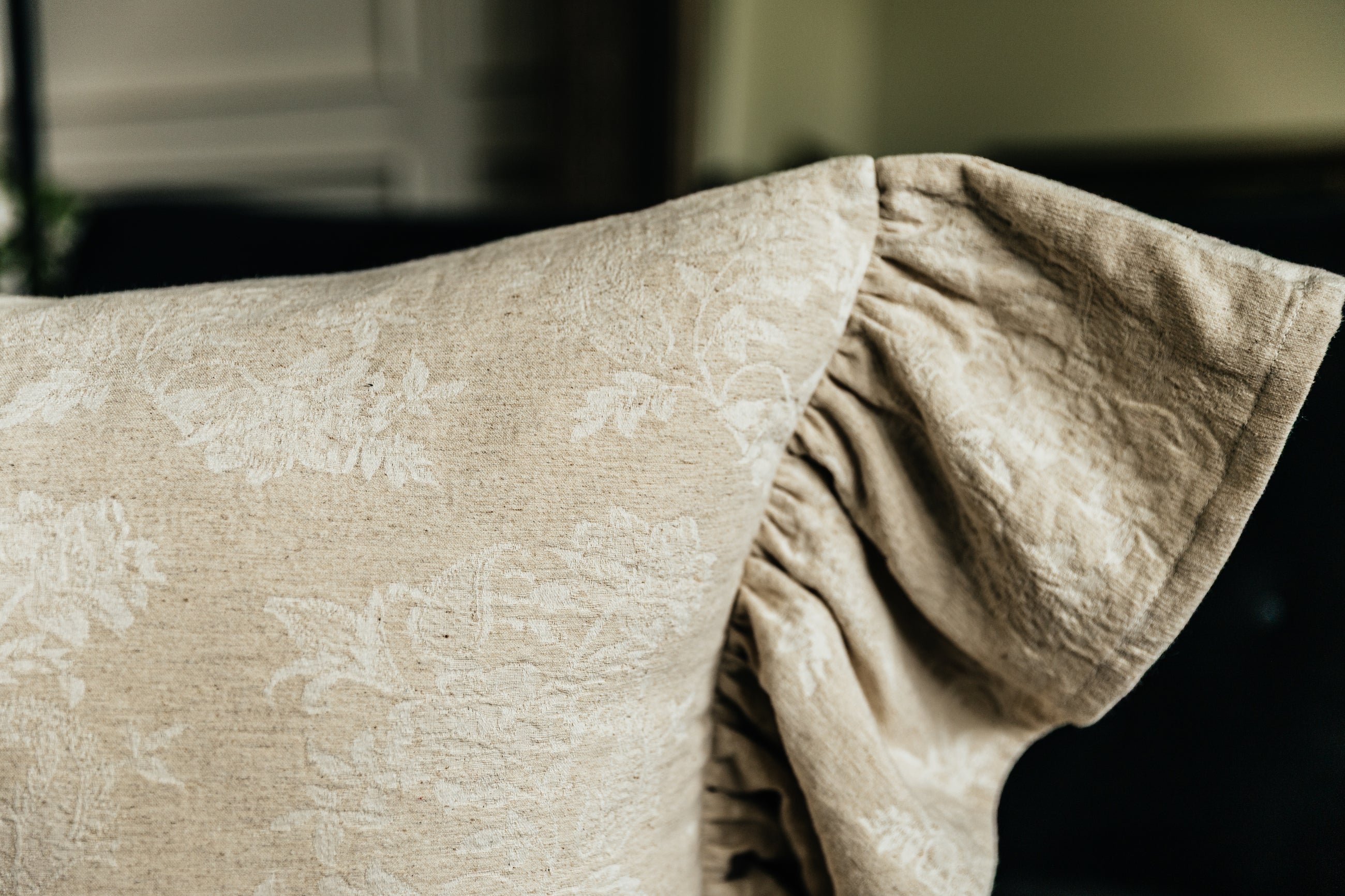 Corner shot of floral embossed tan lumbar