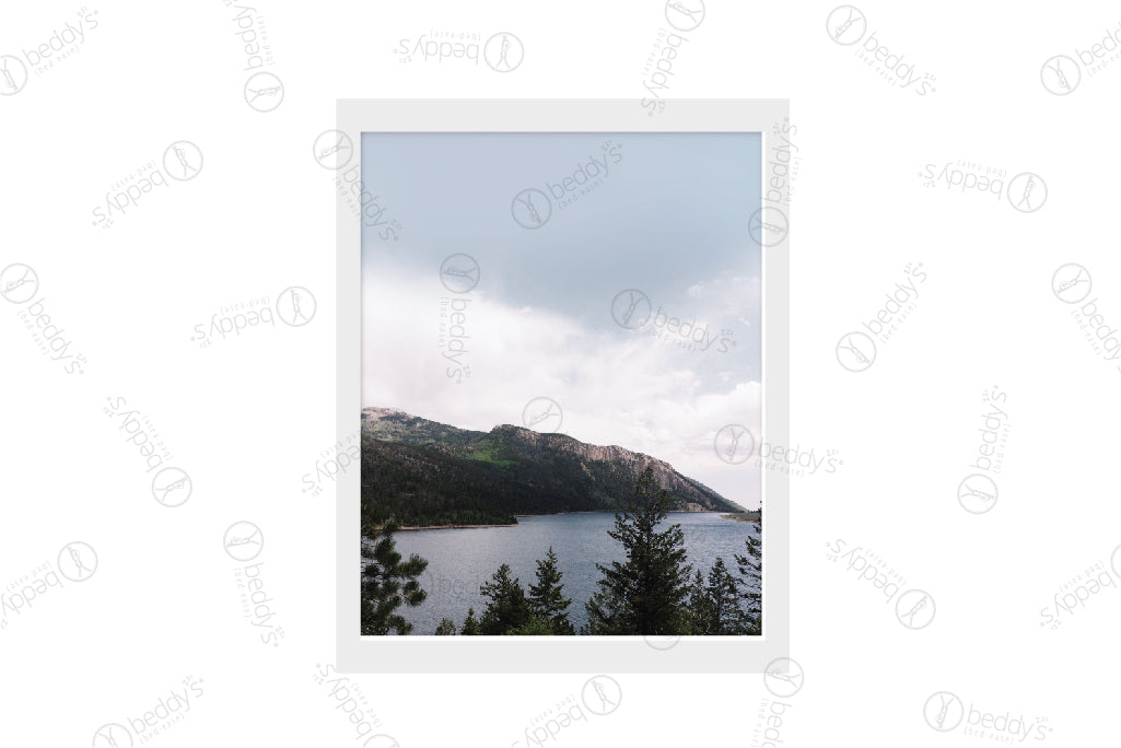 A mountain, trees, and lake digital artwork showcased in a frame. 