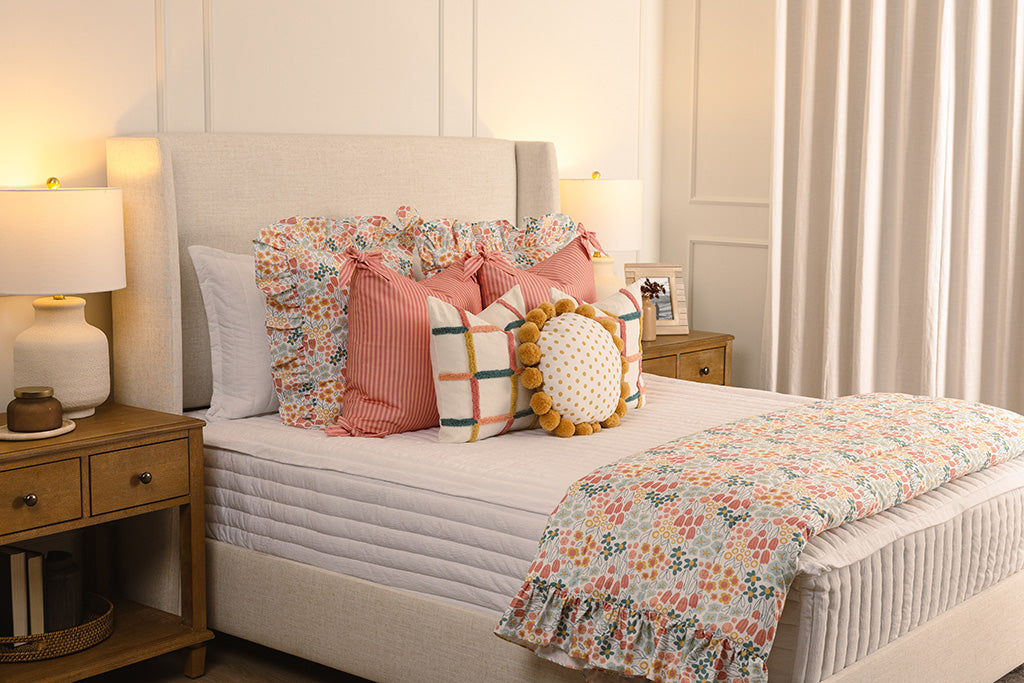 White quilted zipper bedding with multi-color and floral accessories.