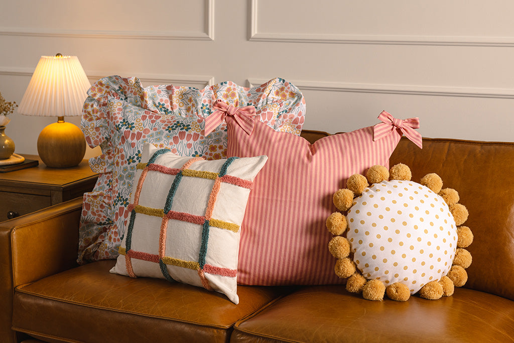 Multi-color and floral accessories on an orange leather couch