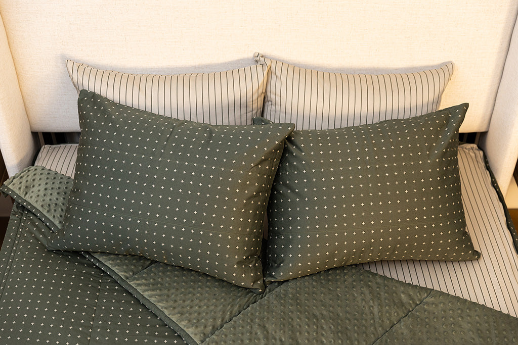Overhead shot of green zipper bedding showing pillowcases and shams