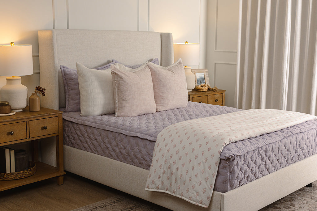 Purple puffed zipper bedding with white and light pink accessories.
