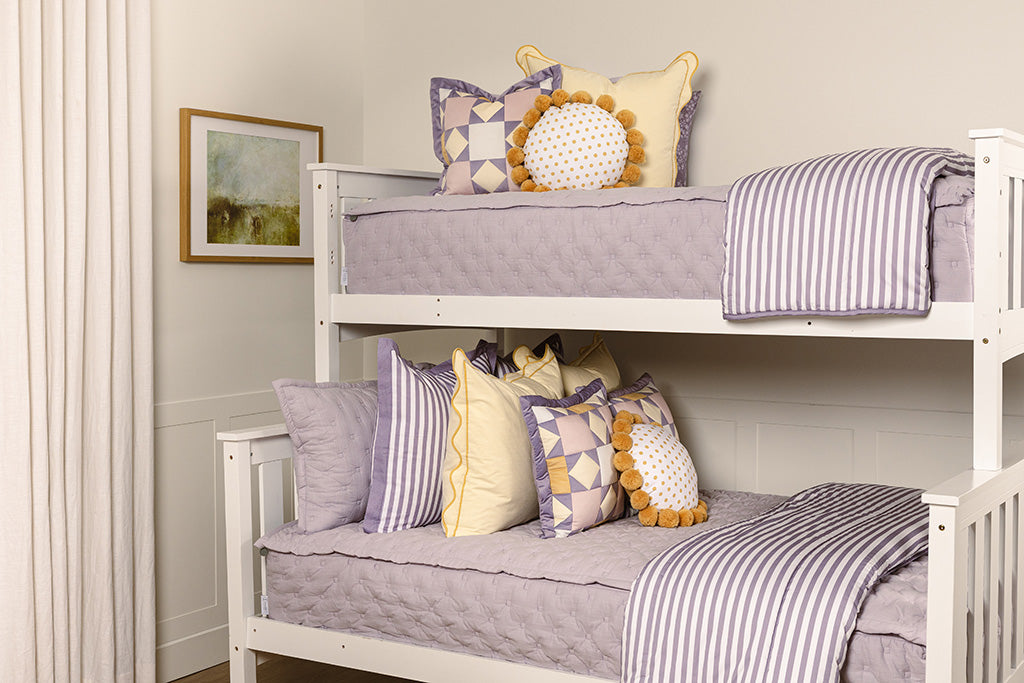 Purple puffed zipper bedding with yellow, purple, and white accessories.