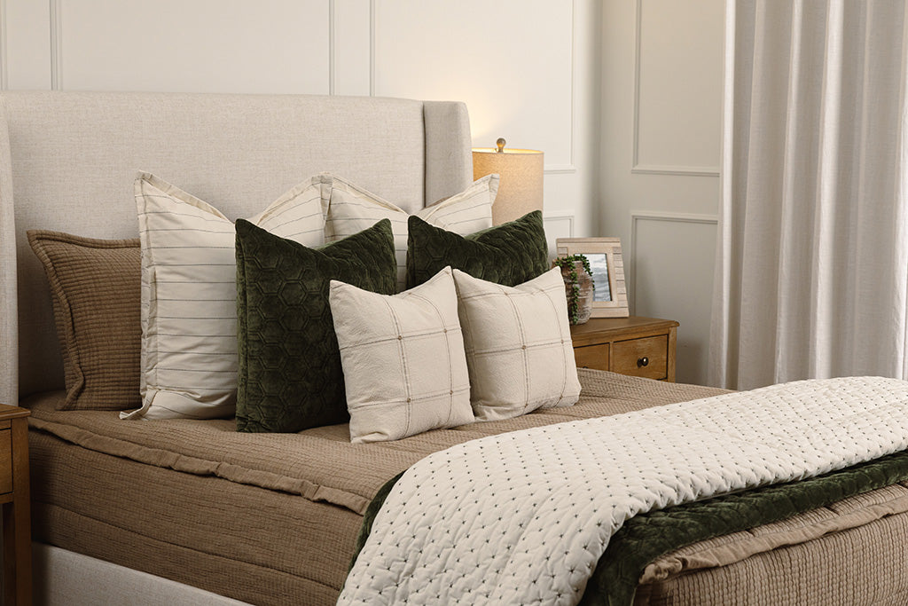 Tan woven zipper bedding with white and green accessories.