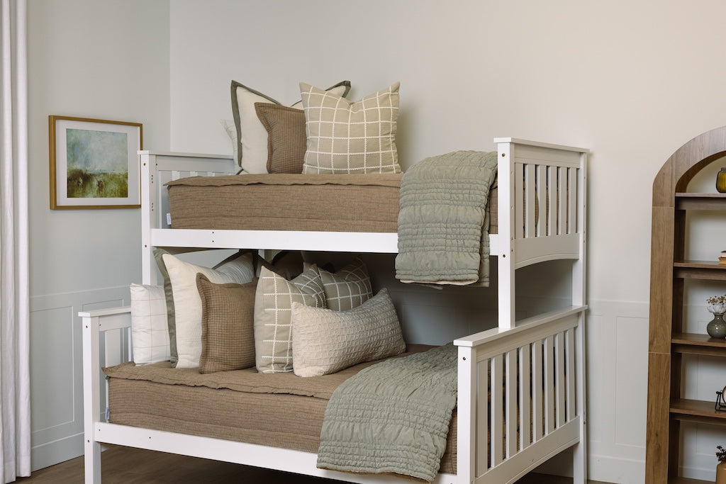 Tan woven zipper bedding with cream and green accessories.