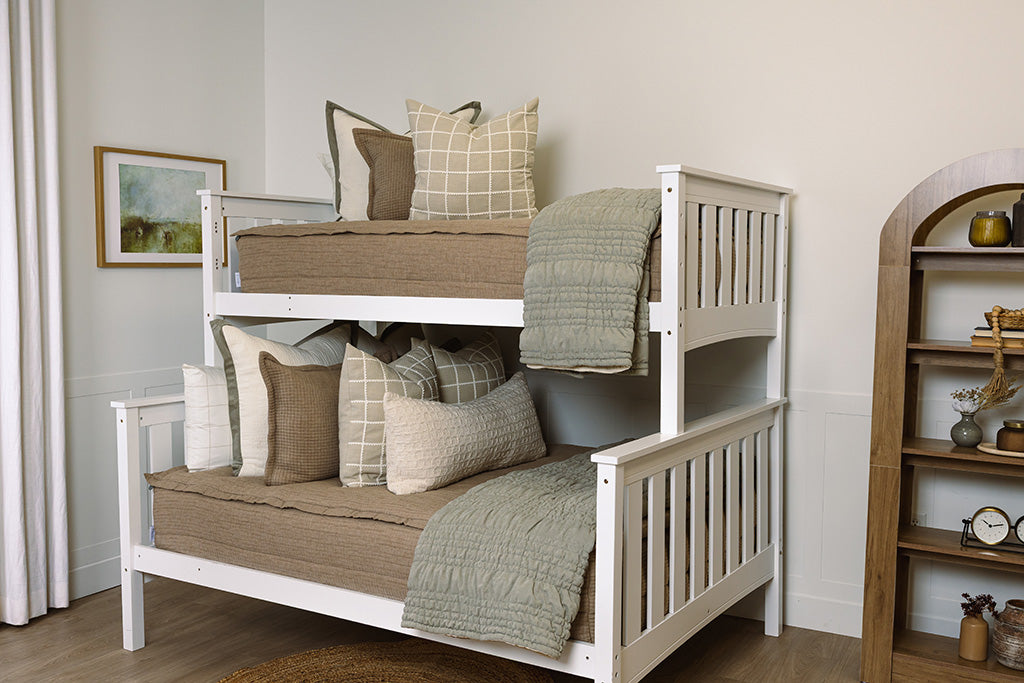 Tan woven zipper bedding with cream and green accessories.