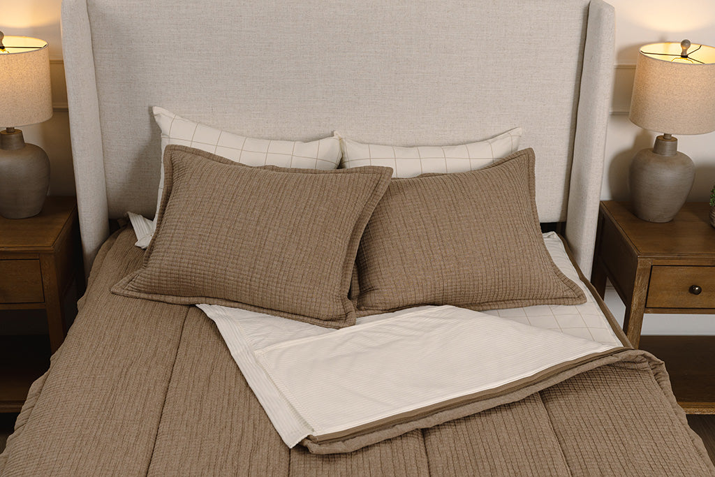 Overhead photo of tan woven zipper bedding with cream and tan plaid bed sheets and cream corduroy minky interior.