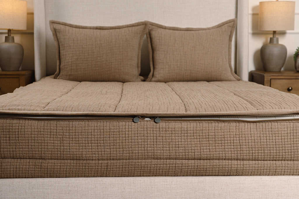 End of bed showing double zippers on brown woven zipper bedding.