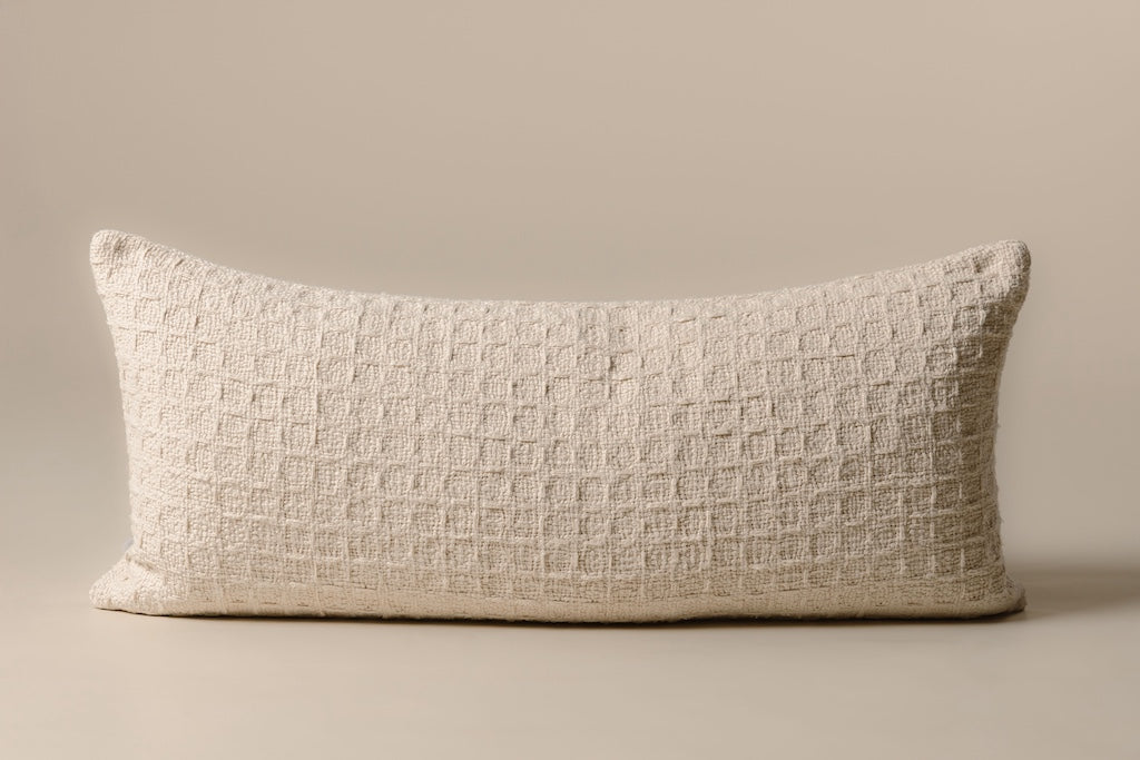 Cream color and an ultra-soft woven fabric XL lumbar pillow on a cream backdrop.