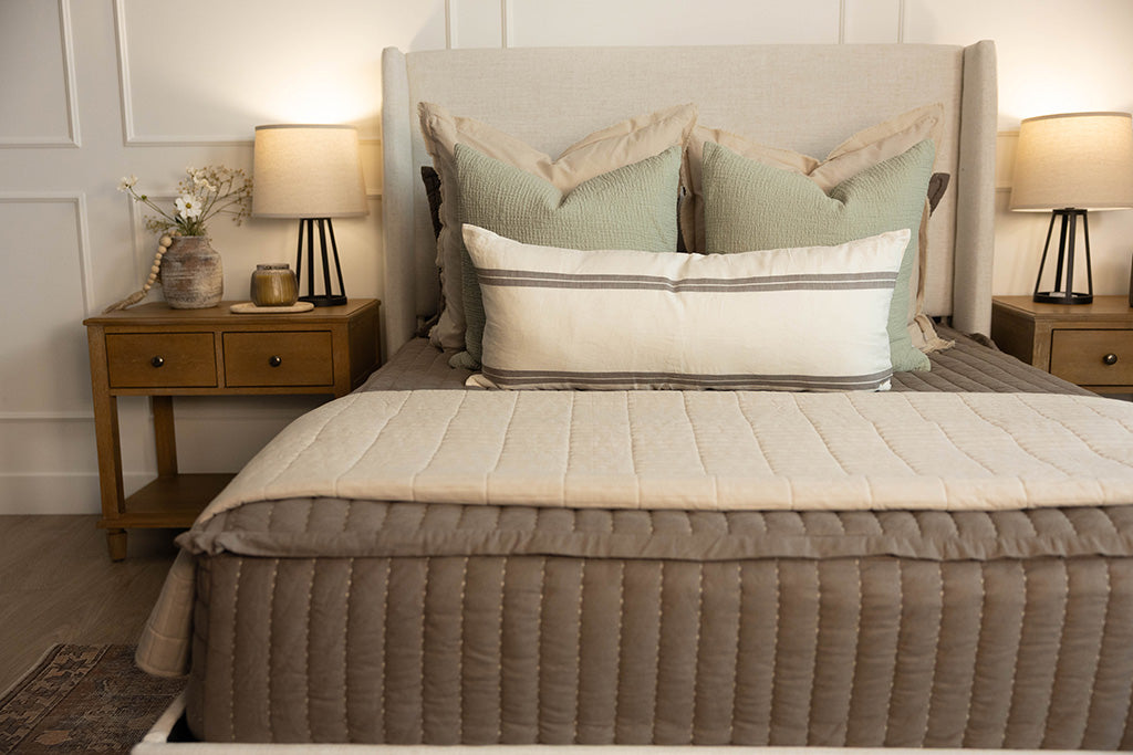 Brown stitched zipper bedding with neutral and sage green bedding accessories