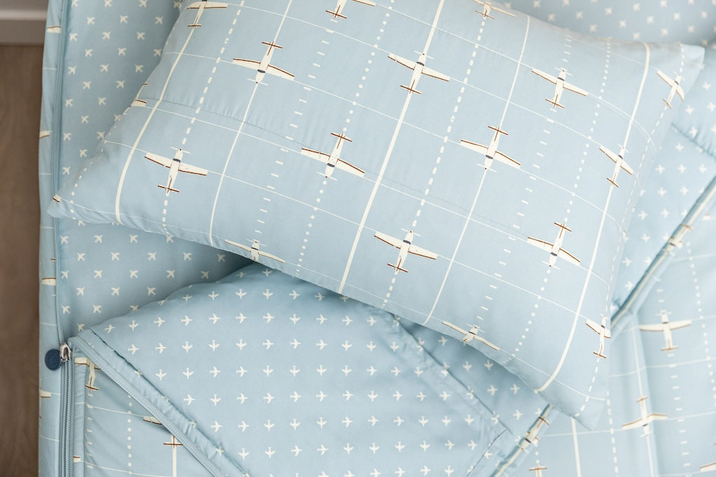 light blue zipper bedding with airplane design
